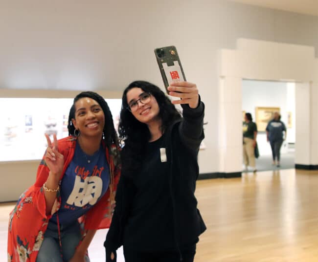 UF students in the museum taking a selfie