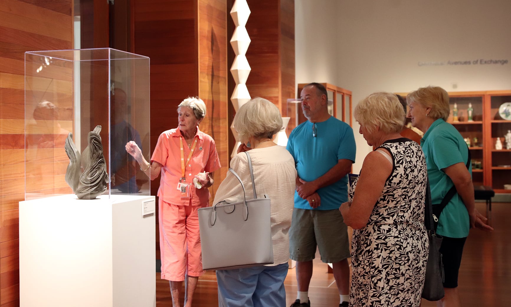 Docent-led tour at the museum, with guests studying a sculpture