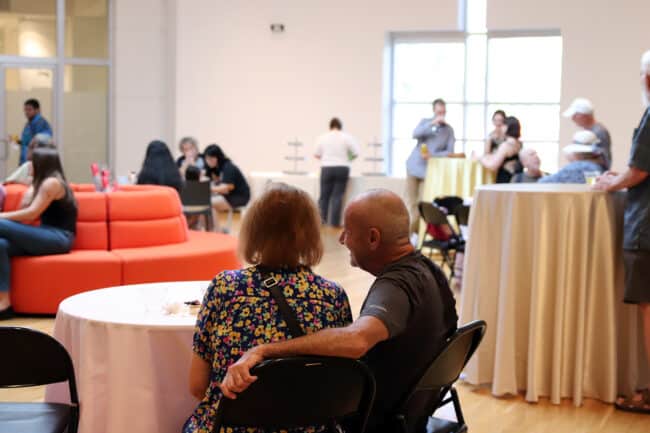 people stitting at a table enjoying Art After Dark at the museum