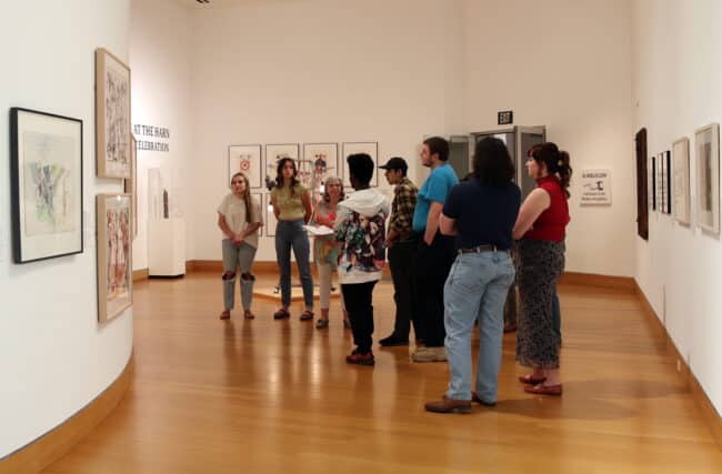 Harn docent with museum visitors on tour in the gallery