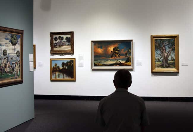 person in gallery observing artwork from the Vickers collection