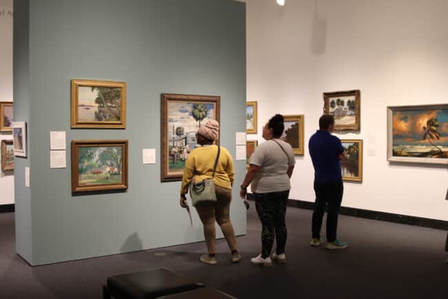 Museum guests in the gallery viewing work from the "Florida Impressions" exhibition