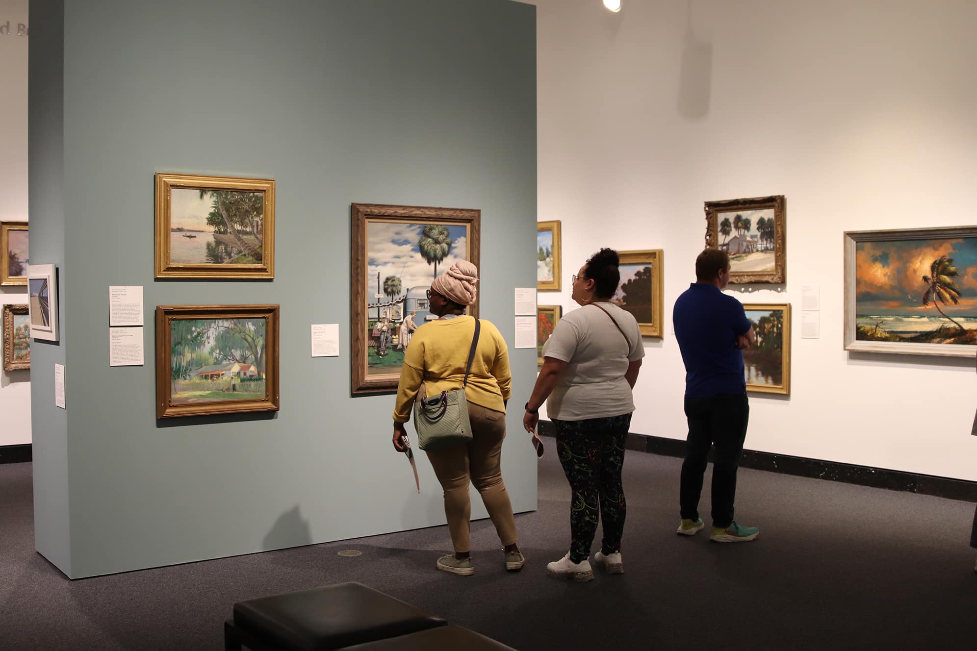 Museum guests in the gallery viewing work from the "Florida Impressions" exhibition