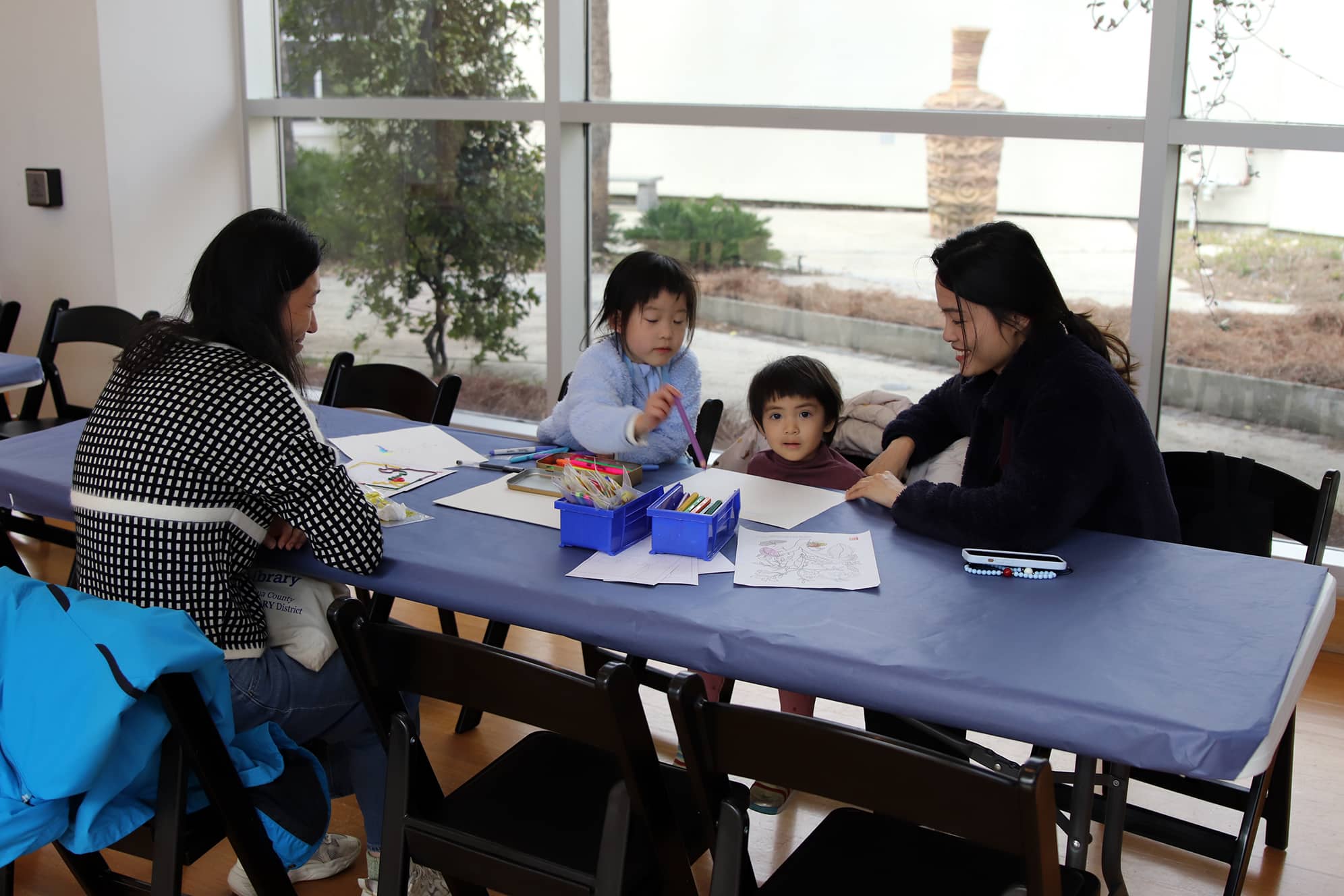 A family enjoying art making at the Art Cart