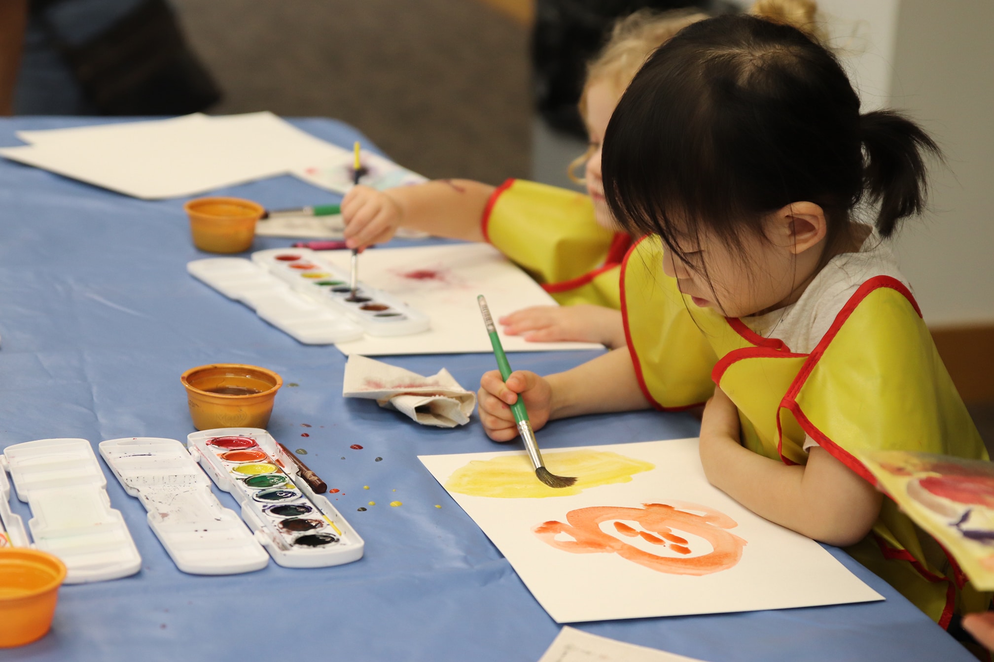 children painting with watercolor during Tot Time