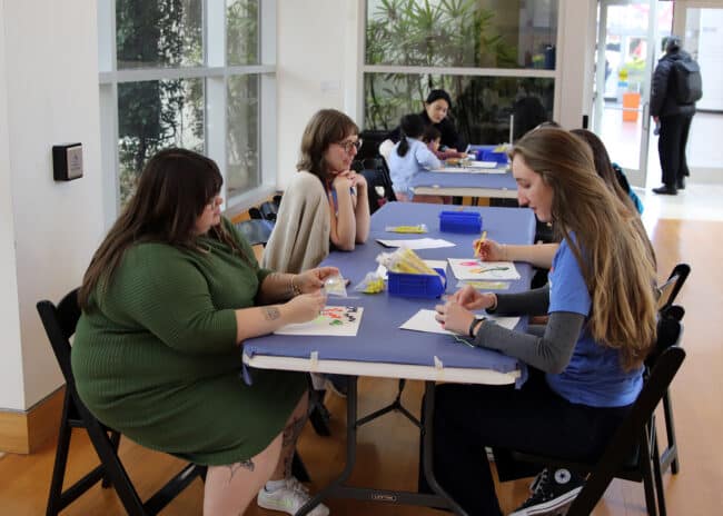 Museum participants making art at the Art Cart