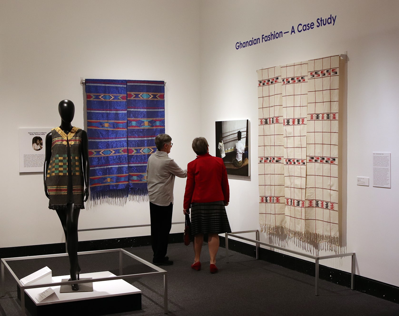 Museum visitors discussing art in the exhibition "Ghanaian Fashion"