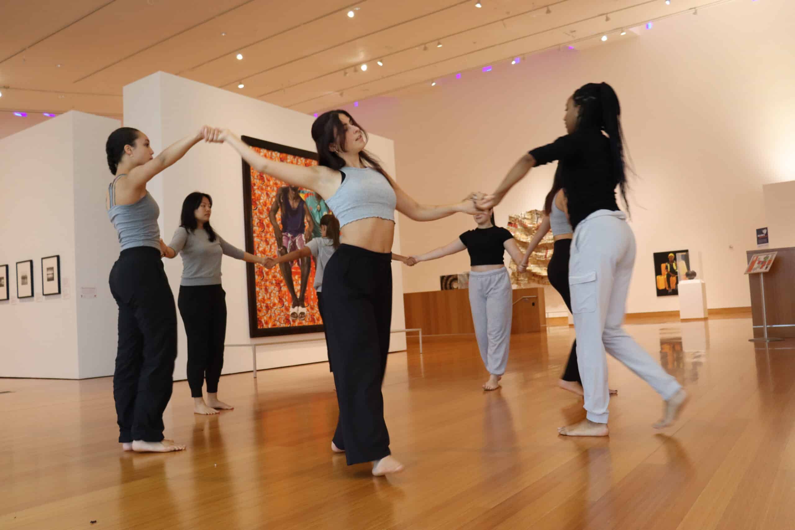 dancers performing in a circle in the contemporary wing