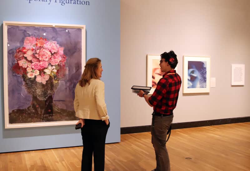visitors at the museum having a conversation in front of a work of art from 