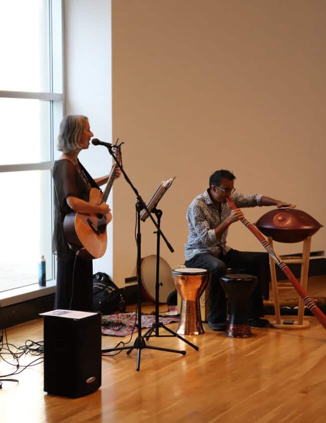 photograph of Shana Smith and Raihan Alam playing musical instruments in the rotunda