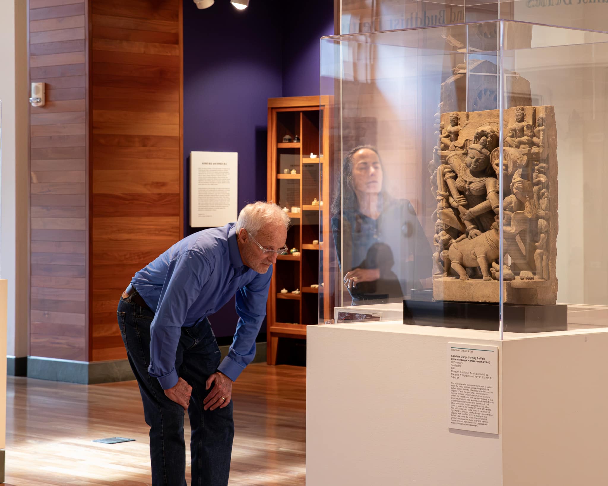 Couple looking at sculpture work in Asian gallery.