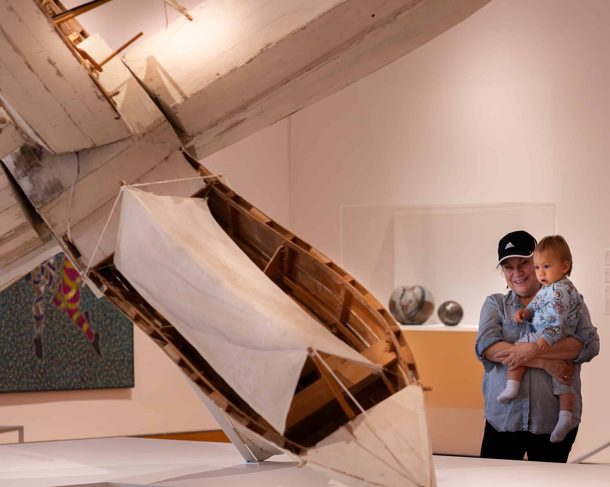 Child and mother looking at artwork.