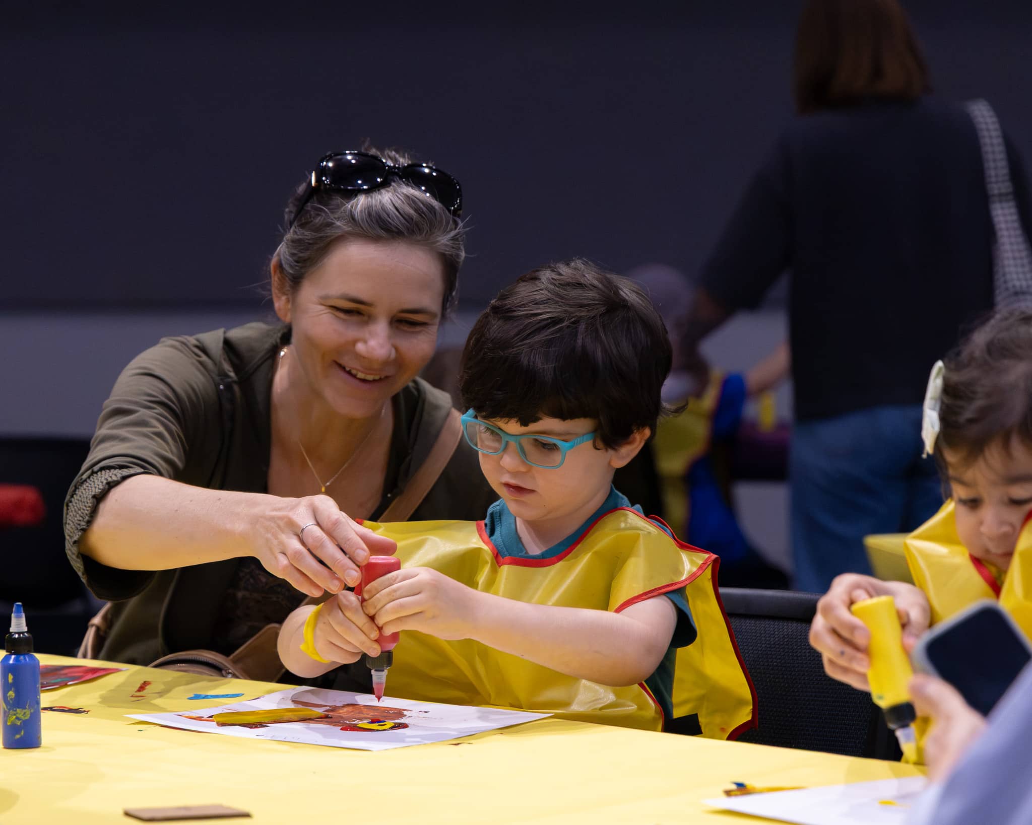 Child and caretaker participating in art activity.